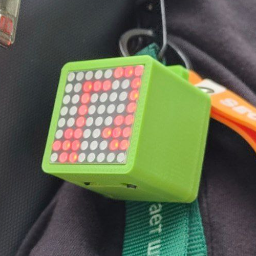 A green cube with an 8x8 monochrome screen on the front.